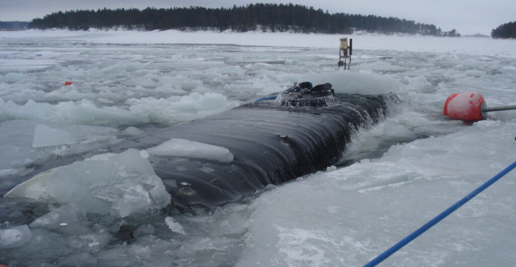 24 pax silvercrest sub surfacing through an ice hole